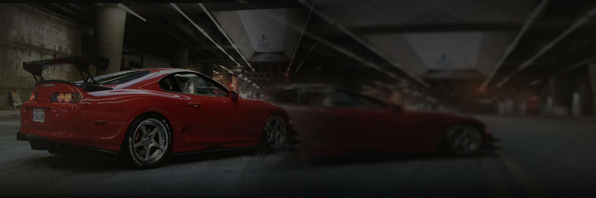 Red performance car in a cinematic tunnel at night